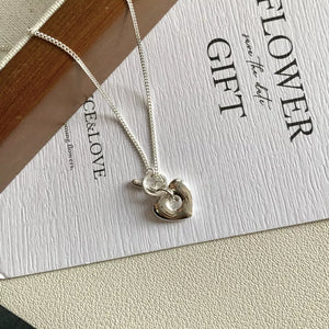 necklace in silver featuring heart pendant and delicate fit