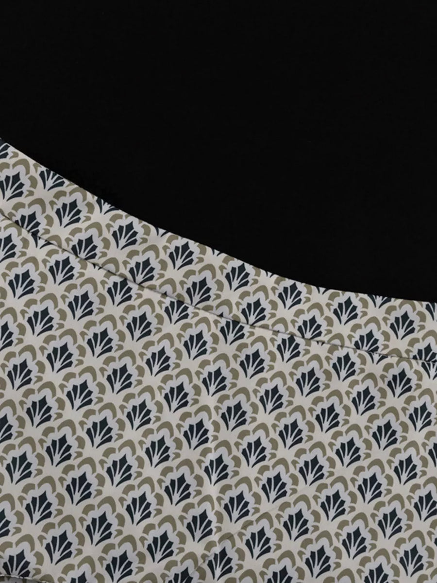 Black top with a cream fabric panel featuring a repeating navy and tan fan pattern.