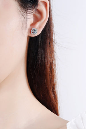 Scalloped halo moissanite stud earrings in silver with a central round cut stone.