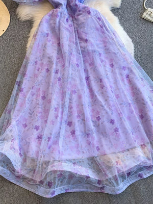 Purple floral maxi dress with sheer overlay and glitter detail.