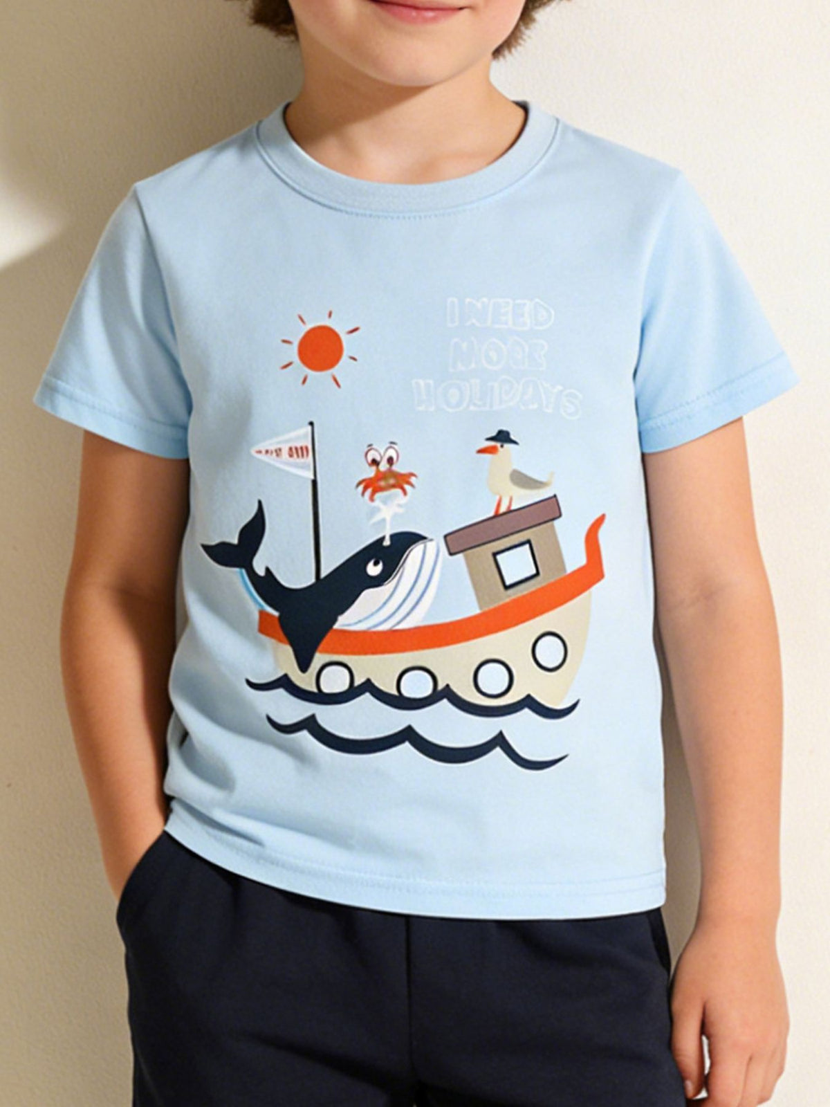 Light blue cotton t-shirt with a whimsical sea adventure graphic featuring a whale, crab, seagull, boat, and text.