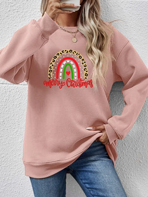 Blush pink crewneck sweatshirt with rainbow Christmas graphic and leopard print detail.
