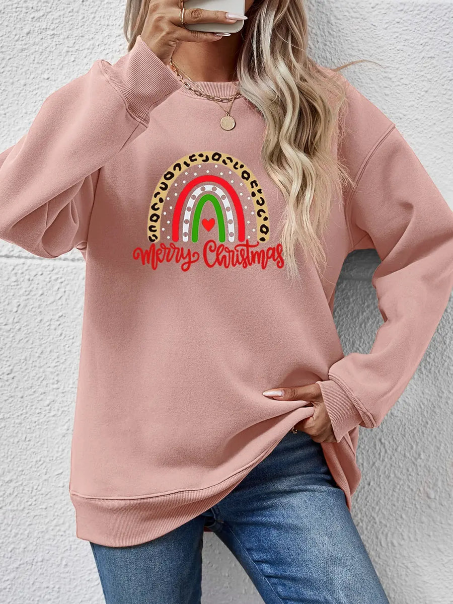 Blush pink crewneck sweatshirt with rainbow Christmas graphic and leopard print detail.