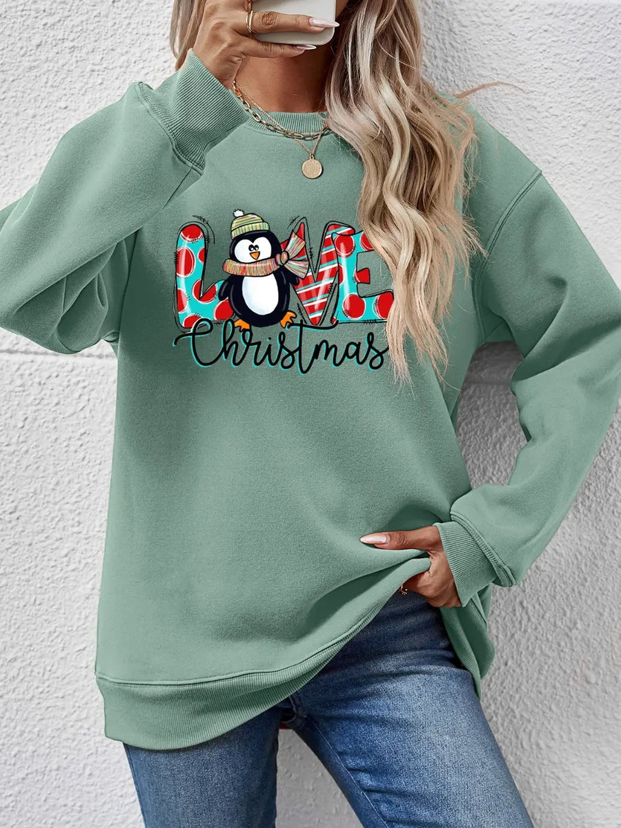 Sage green sweatshirt with a festive penguin graphic and "Christmas" text.
