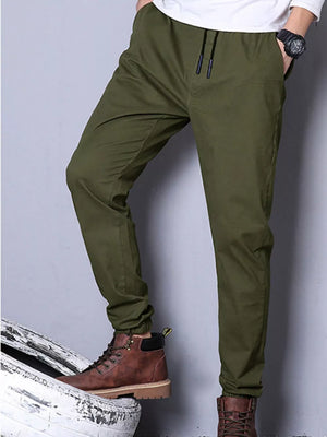 Olive green joggers with drawstring waist and cuffed ankles.
