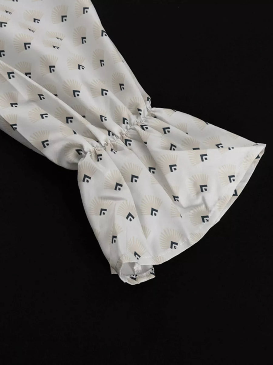 White blouse with fan pattern and ruffled bell sleeves