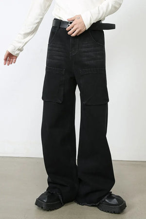 Dark wide-leg denim cargo pants with large flap pockets and frayed hems.