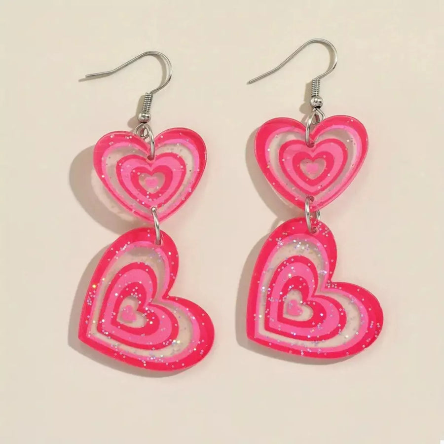Pink glitter heart dangle earrings with layered pink acrylic hearts.