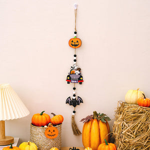 Halloween garland with pumpkin, car with ghosts, bat, and tassel. Multicolor festive decor.