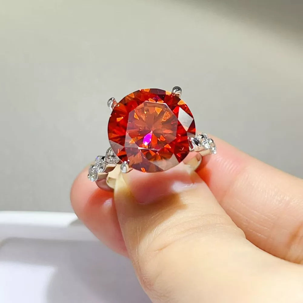 ring in orange-red featuring large center stone and fitted fit