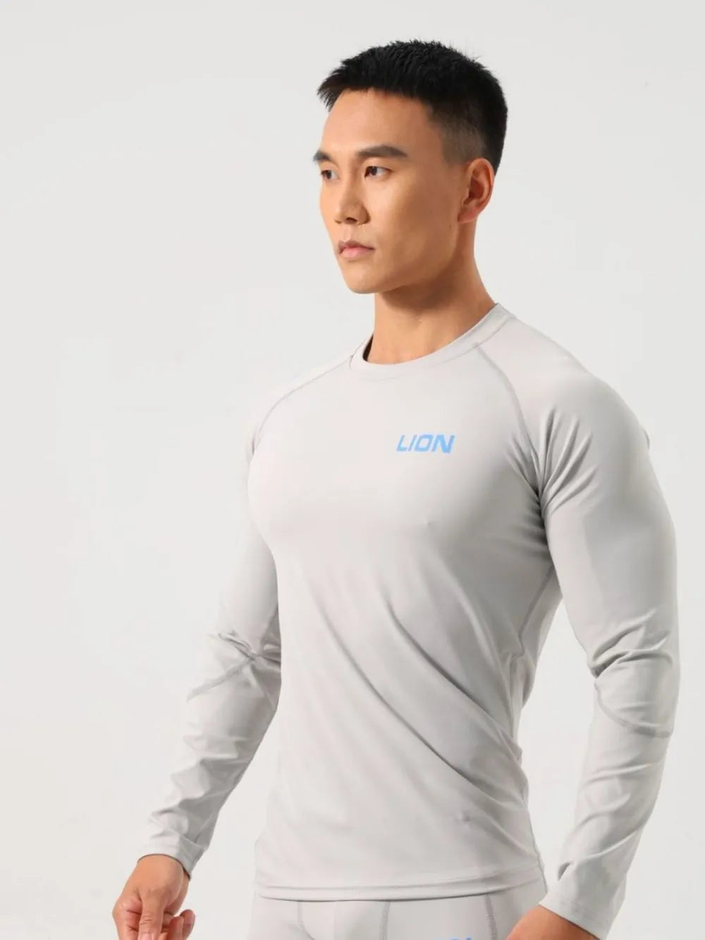 Gray performance raglan sleeve tee with blue logo, crew neck, long sleeves.