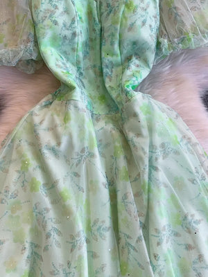 Green floral maxi dress with sweetheart neckline and sheer puff sleeves.