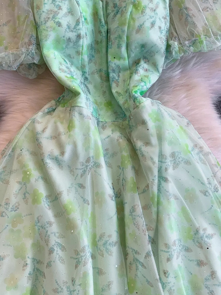 Green floral maxi dress with sweetheart neckline and sheer puff sleeves.