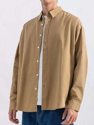 Camel long sleeve button-up shirt with white buttons, layered over a white tee.