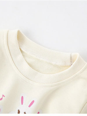 Ivory crew neck sweatshirt with cute rabbit piano graphic, 100% cotton.