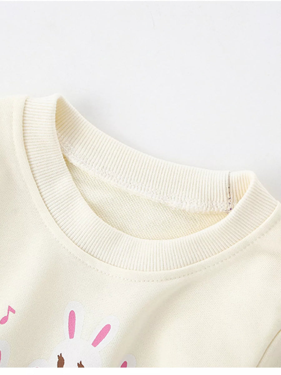 Ivory crew neck sweatshirt with cute rabbit piano graphic, 100% cotton.