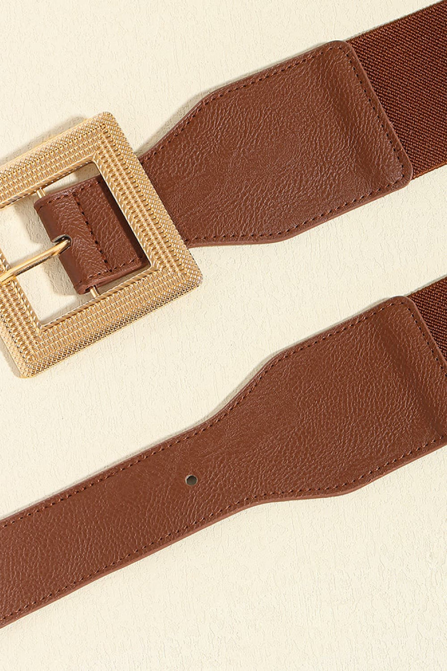 Brown elasticated waist belt with textured gold square buckle and faux leather detailing.