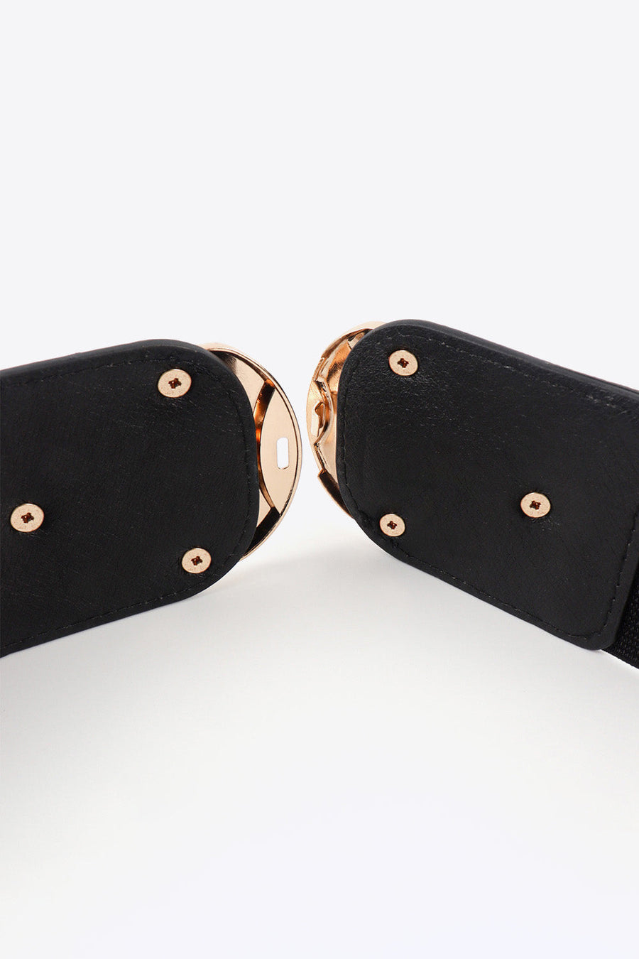 Black elastic belt with double gold buckles and gold stud details.