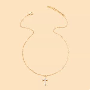 Gold rhinestone cross pendant necklace with a delicate chain.
