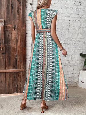 Bohemian maxi dress with ruffle sleeves and a geometric print in teal, orange, and white.