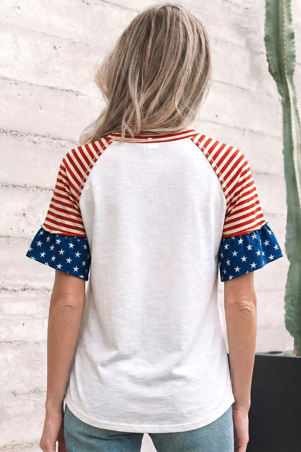 White t-shirt with ruffled star-print sleeves and striped raglan sleeves.