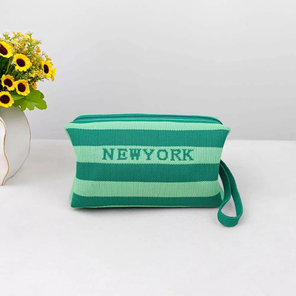 Green striped small cosmetic bag with NEWYORK text and wrist strap