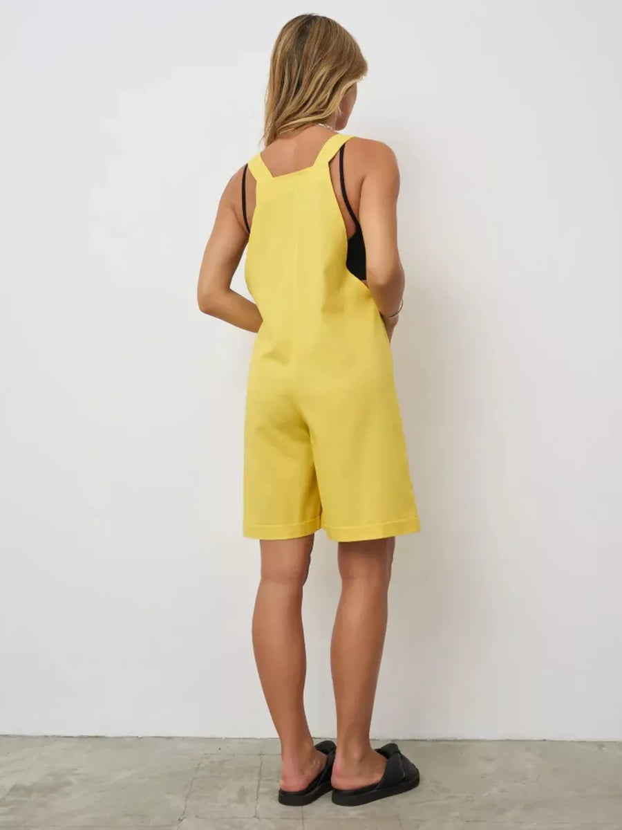 Yellow cotton tie-strap romper with pockets and shorts.