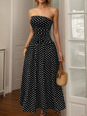 Black polka dot strapless maxi dress with a ruched bodice and full skirt.