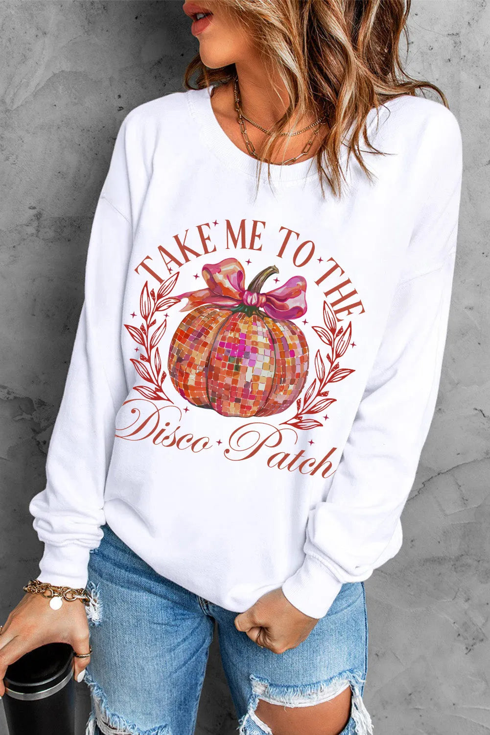 White roundneck sweatshirt with disco pumpkin graphic and text.