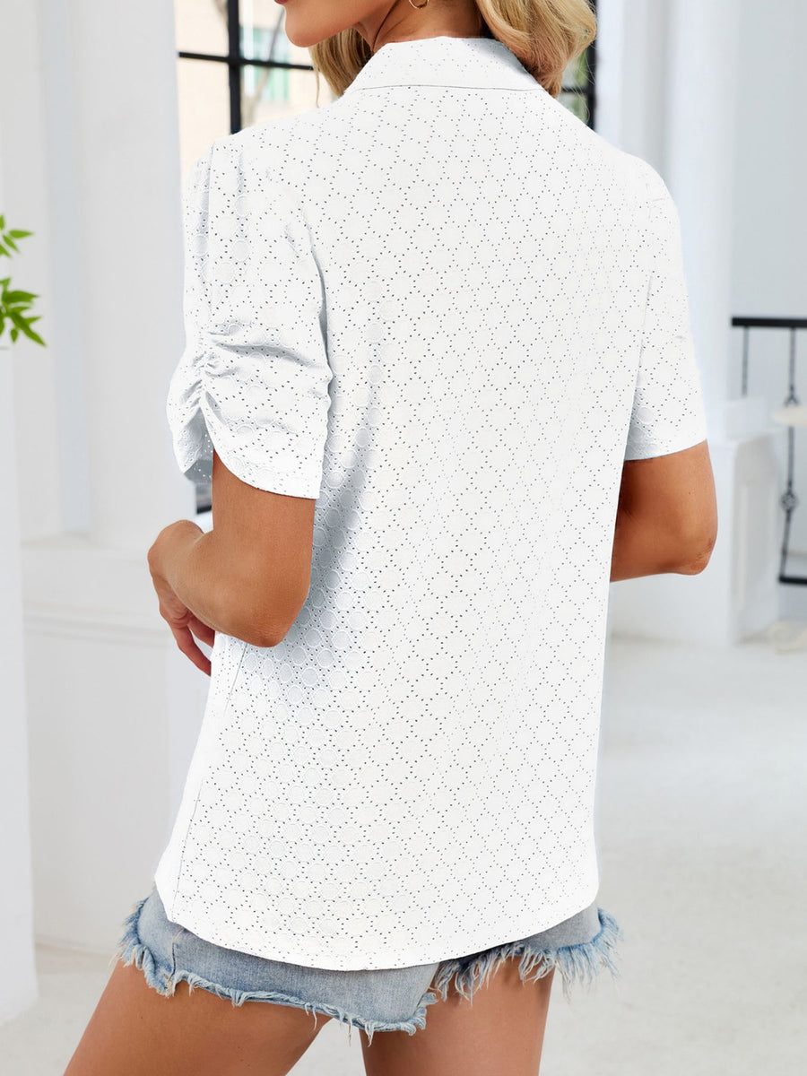White eyelet ruched short sleeve blouse with a collared neckline.