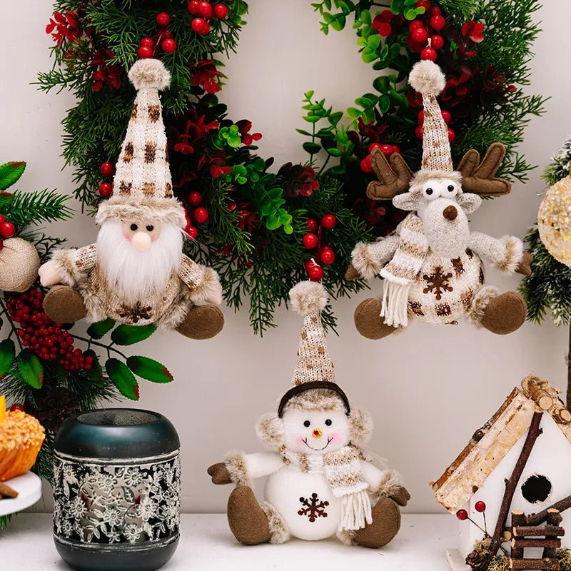 Christmas ornaments: gnome, reindeer, and snowman plush figures with knit hats and scarves.