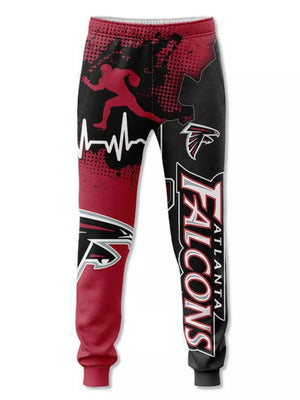 Atlanta Falcons sweatpants with red and black gradient, football player graphic, and team logo.