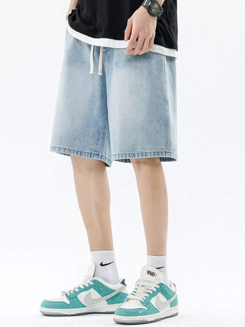 Light wash denim shorts with a relaxed fit and drawstring waist.