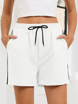 Heathered white jogger shorts with black drawstring and sporty side trim