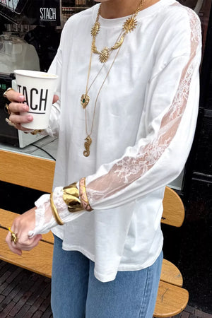 White long sleeve shirt with delicate lace paneling on sleeves and crew neckline.