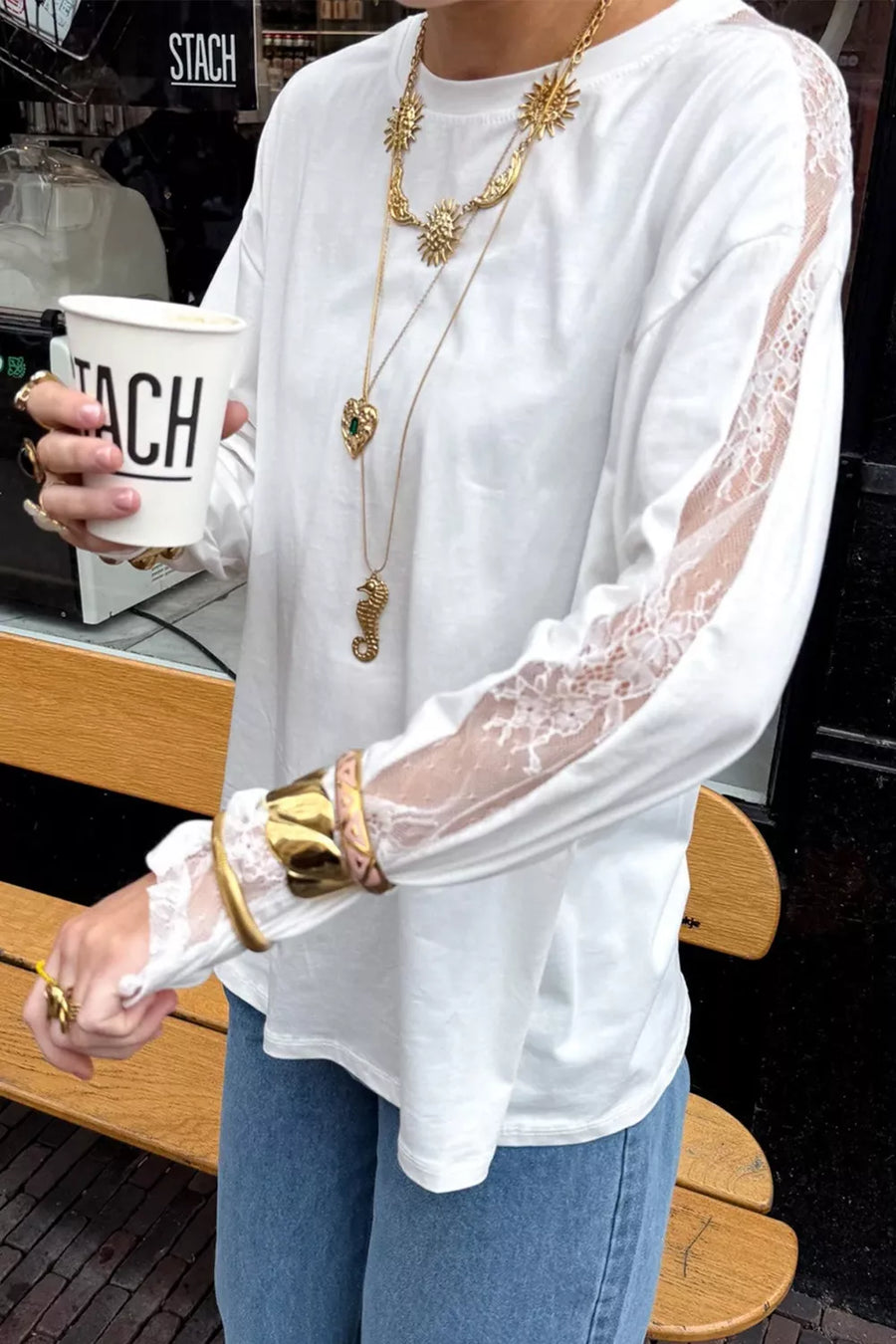 White long sleeve shirt with delicate lace paneling on sleeves and crew neckline.