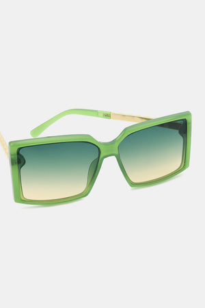 Green geometric sunglasses with gradient lenses and gold accents.