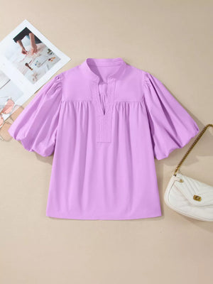 Lavender cotton shirt with notched neckline and voluminous puff sleeves.