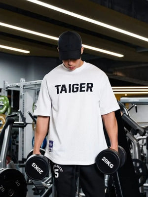 White mesh oversized t-shirt with black TAIGER graphic and short sleeves.