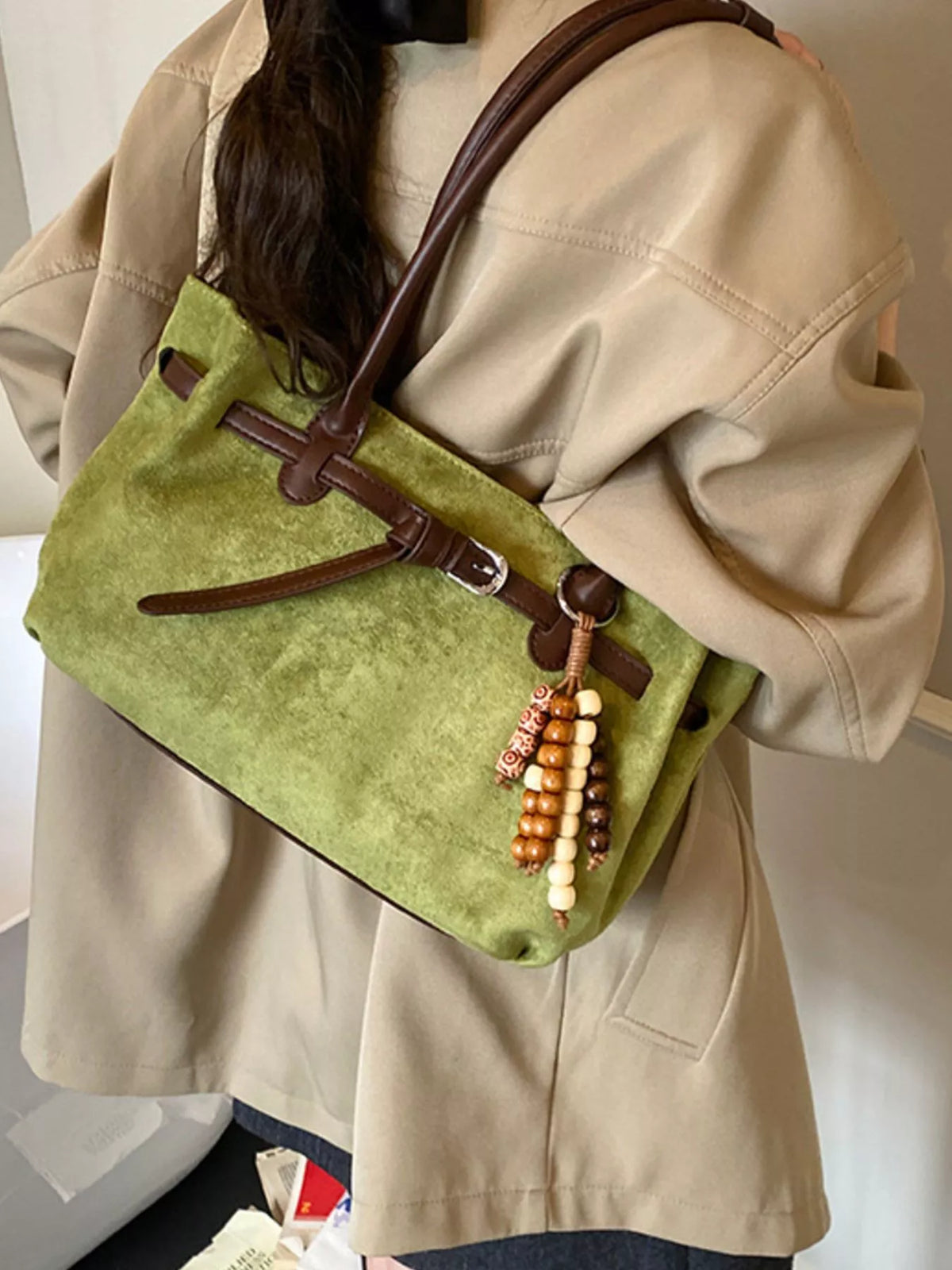 Green suede tote bag with beaded detail and brown leather straps