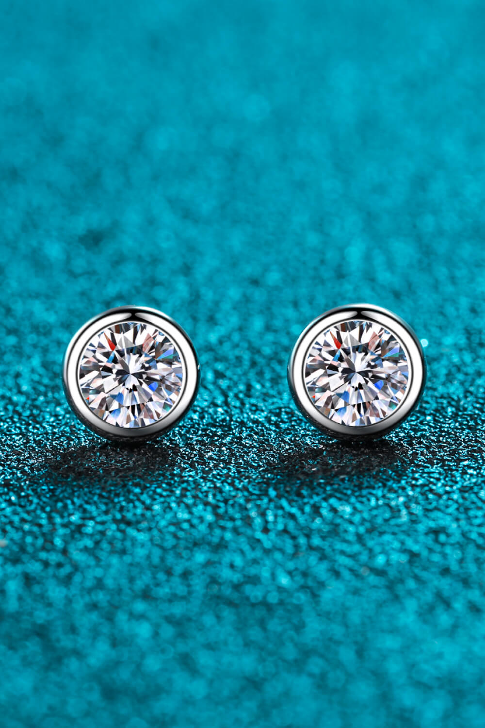 Prismatic Halo Stud Earrings in silver feature a round, brilliant-cut stone set in a polished bezel.