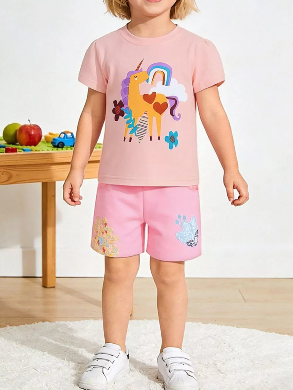 Pink cotton toddler unicorn rainbow t-shirt and shorts set with embroidered details.