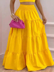 Yellow ruffled crop top and tiered maxi skirt set with smocked waist.