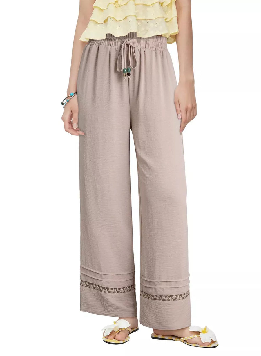 Tan relaxed wide-leg maternity pants with drawstring and embroidered hem detail