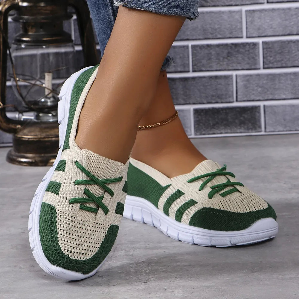 Breathable knit lace-up sneakers in beige and dark green with white soles.