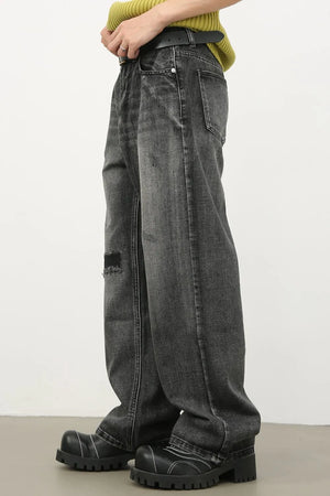 Baggy fit dark washed denim jeans with knee rip detail.