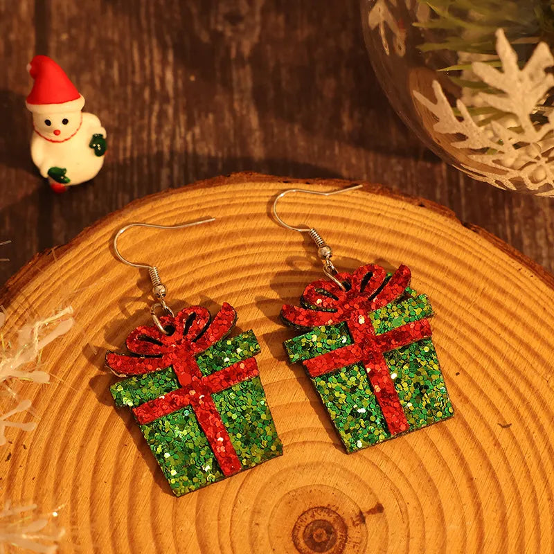 Festive green glitter gift box drop earrings with red ribbon detail.