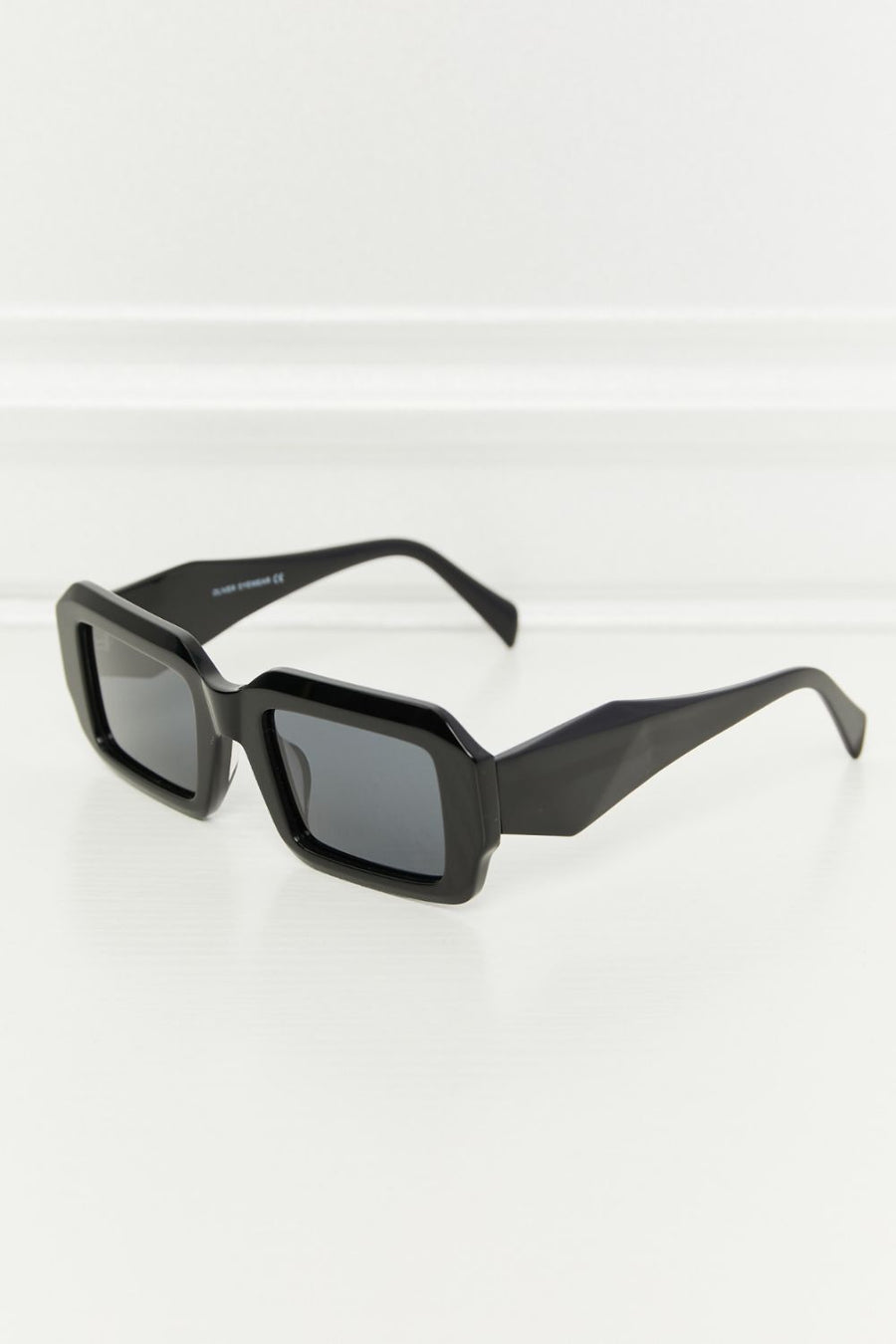 Black geometric frame polarized sunglasses with acetate material.
