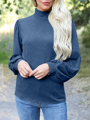 Dusty blue mock neck top with puff sleeves and button back detail