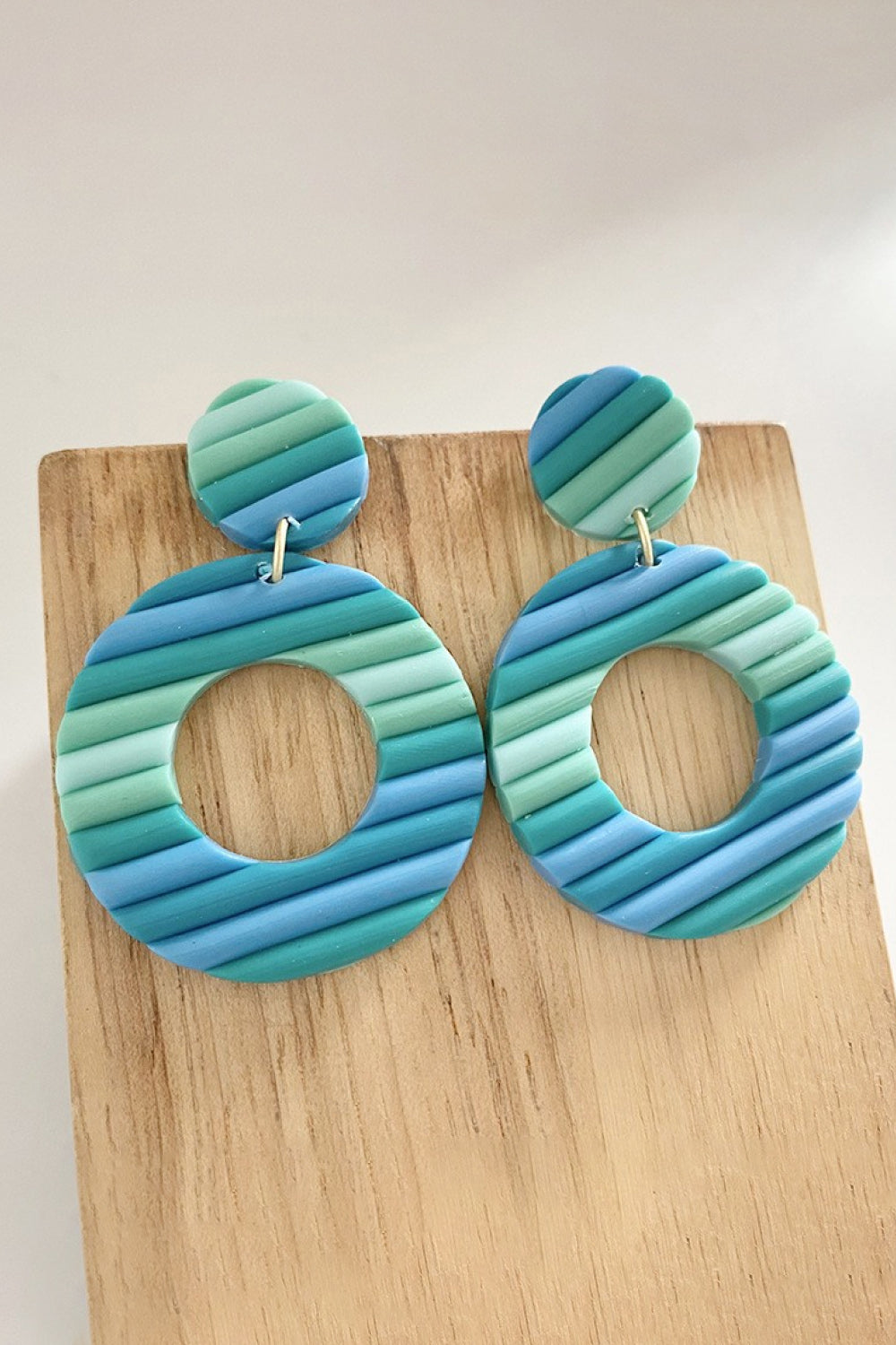 Textured hoop earrings in aqua with striped pattern and circular design